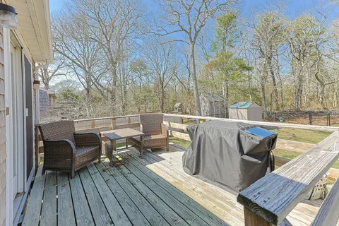 a view of a deck with chairs and wooden floor