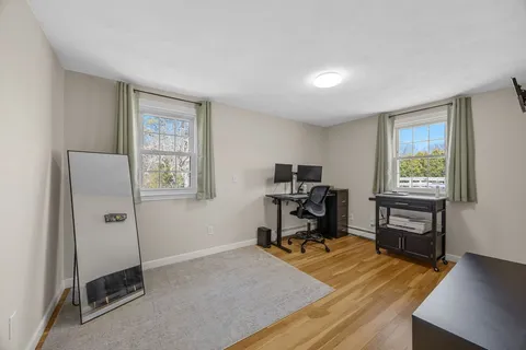 a view of a workspace with furniture and a window