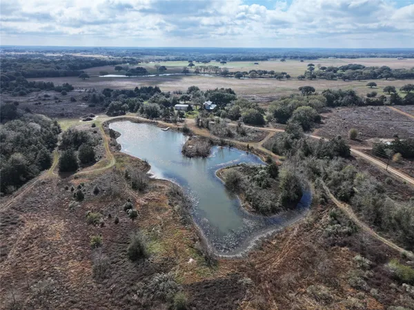 a view of a lake with beach and city space