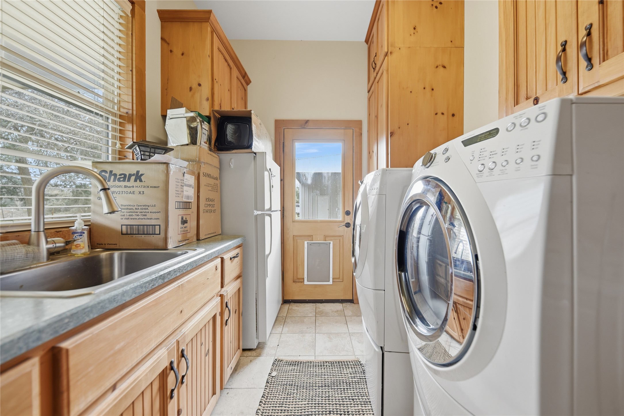 12218 Frantz Road Cat Spring, TX 78933 - Photo 14 of 25 a view of a kitchen with a sink washer and dryer