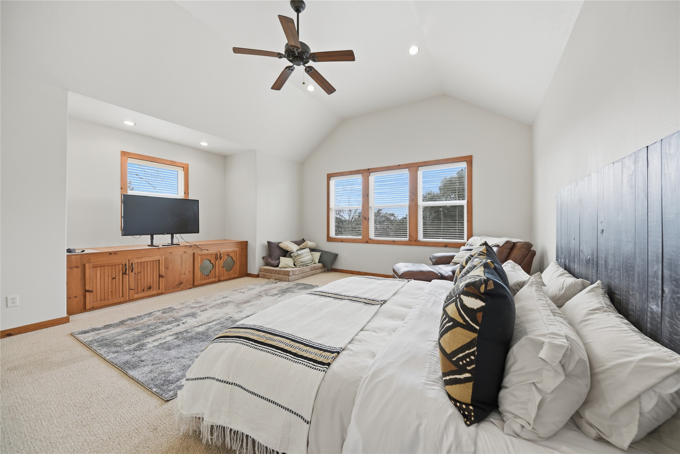 12218 Frantz Road Cat Spring, TX 78933 - Photo 8 of 25 a spacious bedroom with a large bed and a flat screen tv