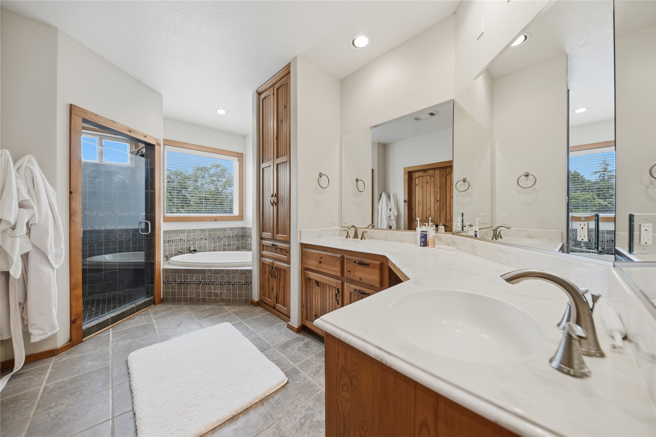 12218 Frantz Road Cat Spring, TX 78933 - Photo 9 of 25 a spacious bathroom with a tub sink and mirror
