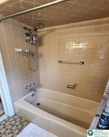 a bathroom with a bathtub and shower