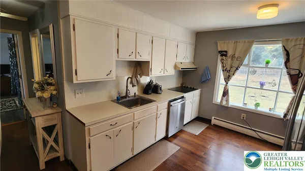 a kitchen with a sink a stove and cabinets