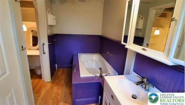 a view of living room with furniture and a mirror