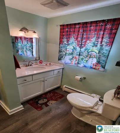 a room with a window bed and flat screen tv