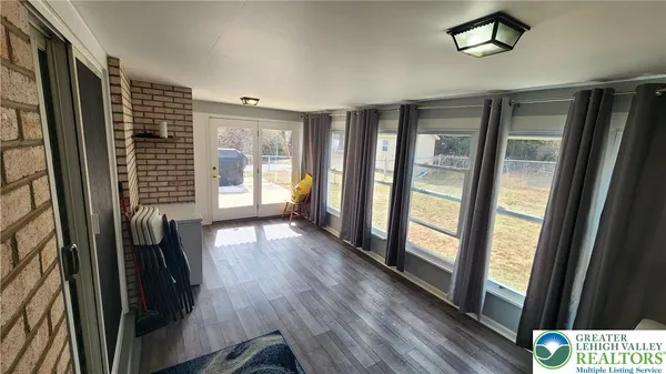 a view of hallway with wooden floor and stairs