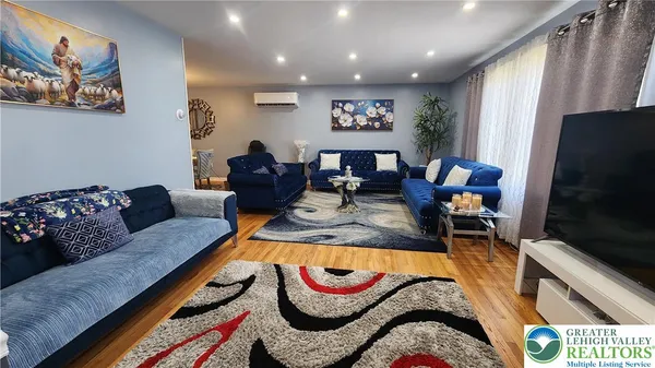 a living room with furniture and a flat screen tv