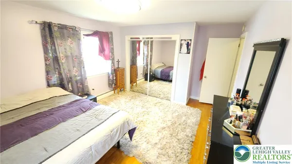 a bedroom with a bed and a dresser