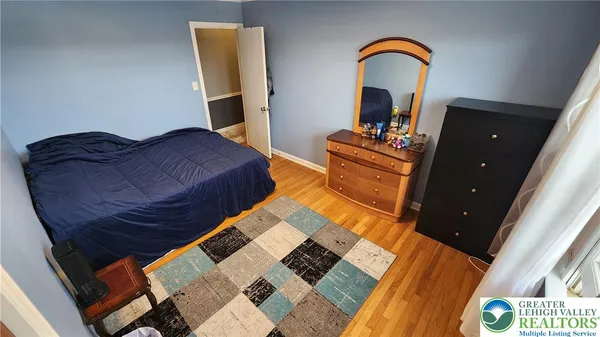 a bedroom with a bed and a dresser