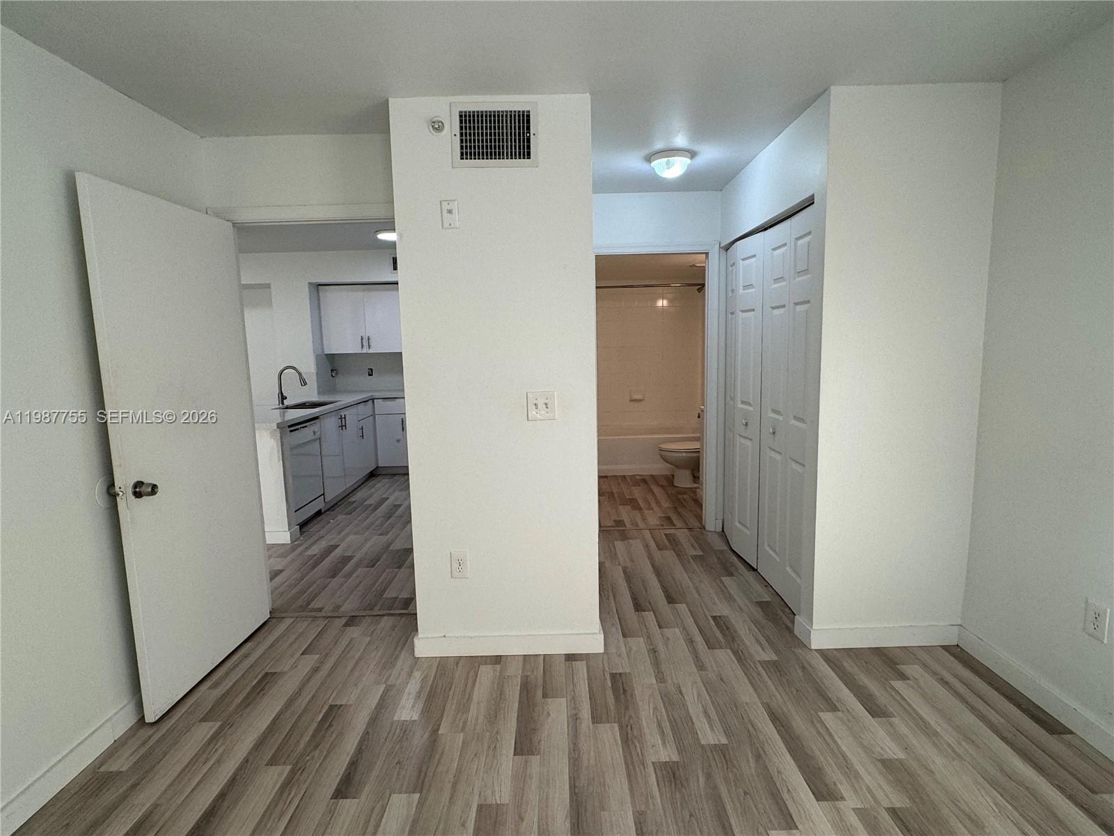 2071 Renaissance Boulevard, Unit 104 Miramar, FL 33025 - Photo 15 of 17 a view of a hallway with wooden floor