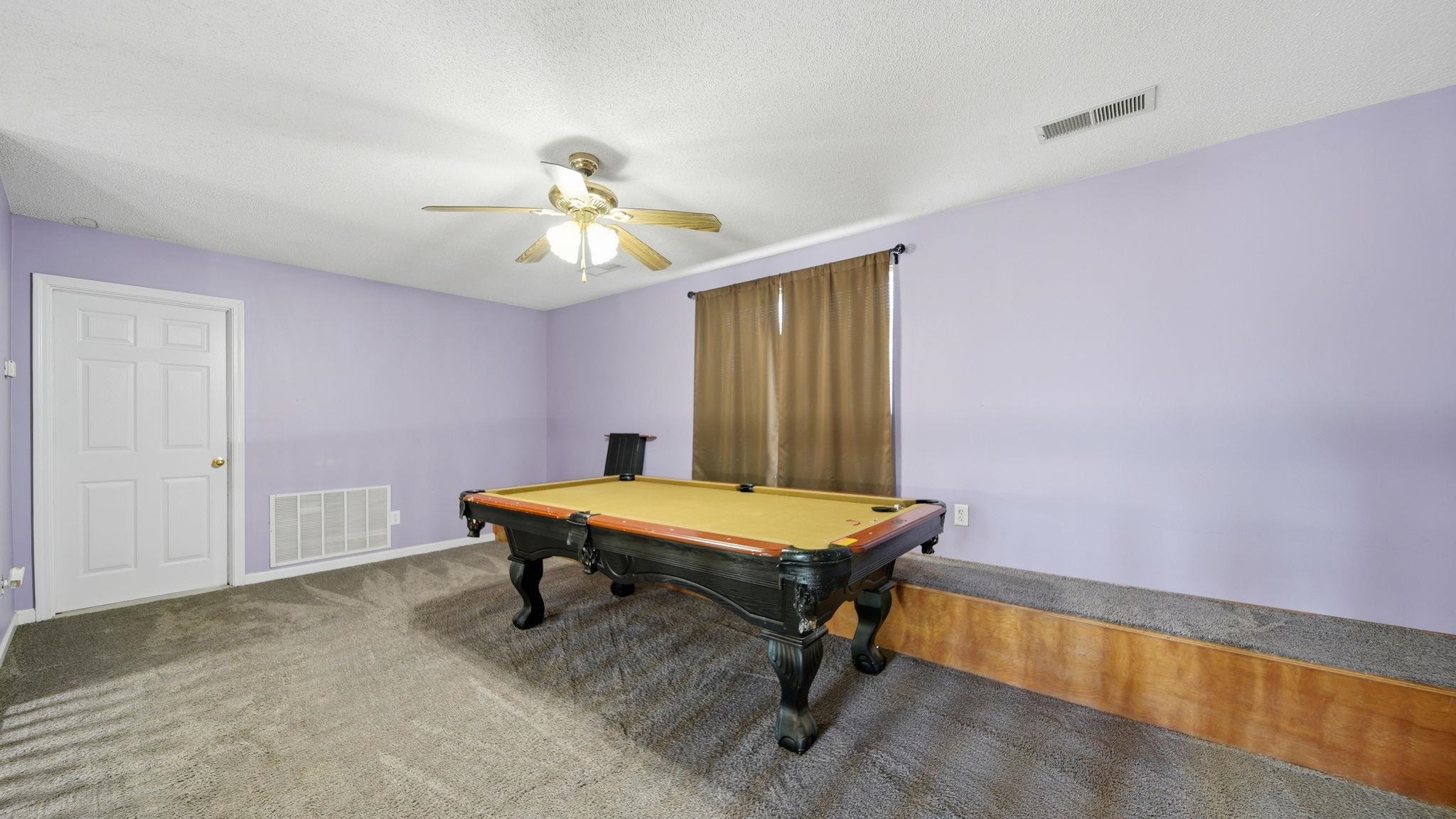 217 Rae Drive Munford, TN 38058 - Photo 27 of 40 Versatile room featuring light-colored walls, carpet flooring, a ceiling fan with integrated lighting, and a single window with curtain rods