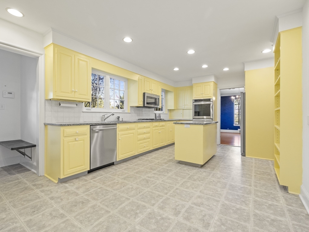110 Pickwick Road Newton, MA 02465 - Photo 12 of 27 a kitchen with a sink dishwasher stove top oven and cabinets