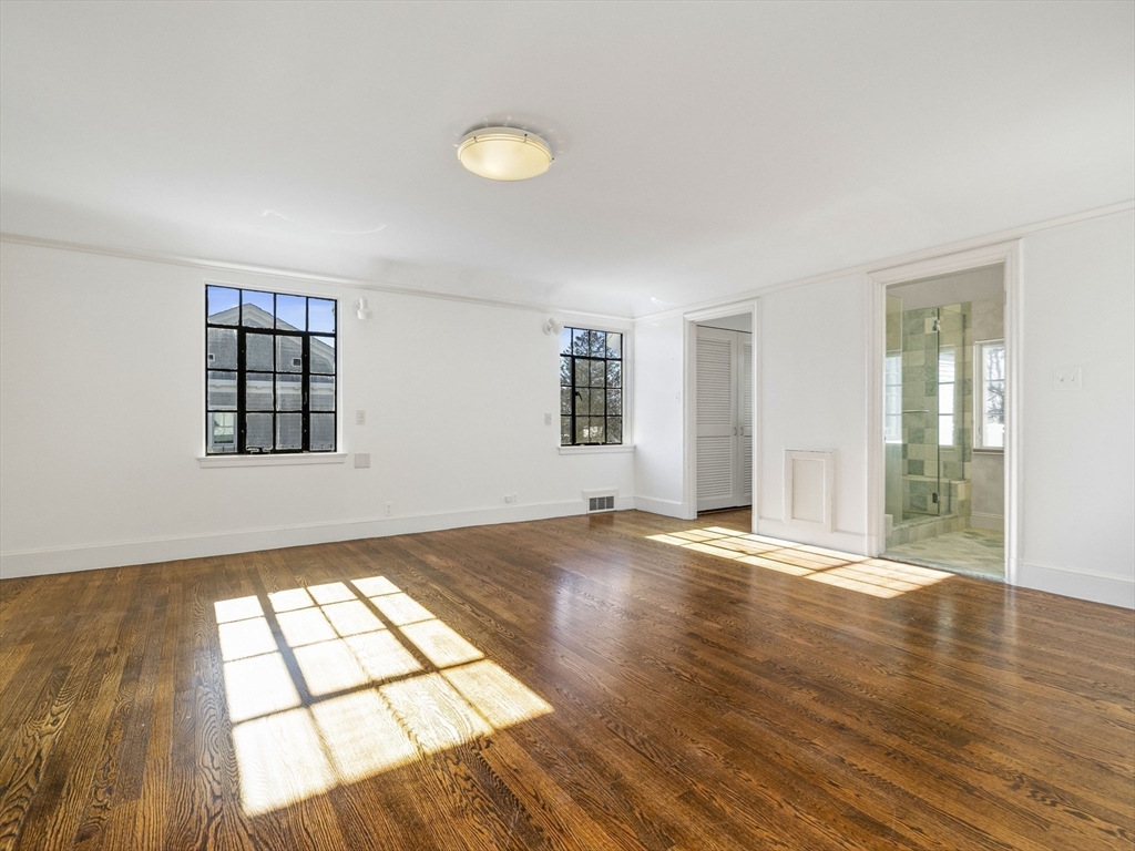 110 Pickwick Road Newton, MA 02465 - Photo 16 of 27 an empty room with wooden floor and windows