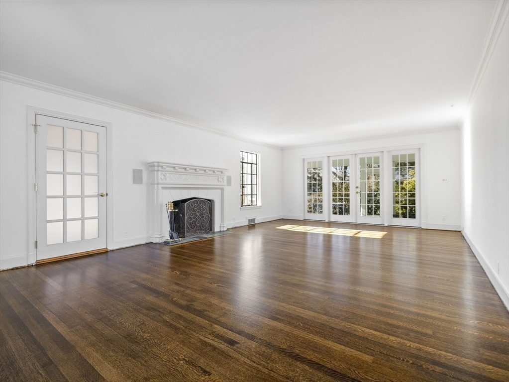 110 Pickwick Road Newton, MA 02465 - Photo 6 of 27 a view of empty room with wooden floor and fireplace