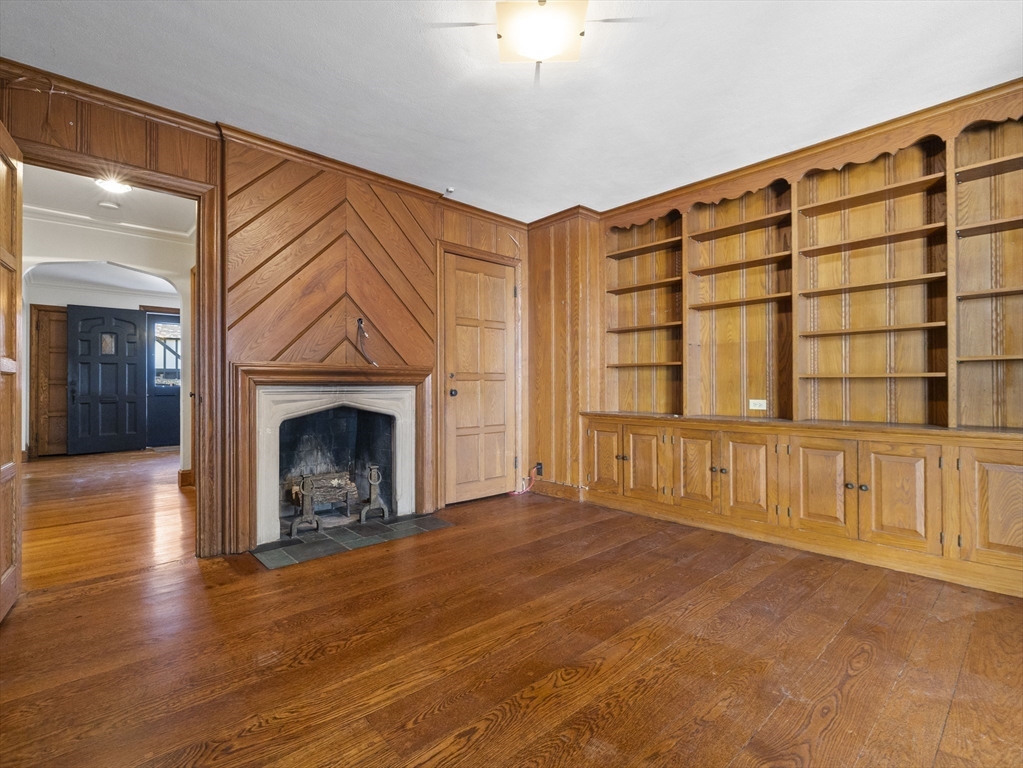 110 Pickwick Road Newton, MA 02465 - Photo 9 of 27 a view of an empty room with a fireplace and a window