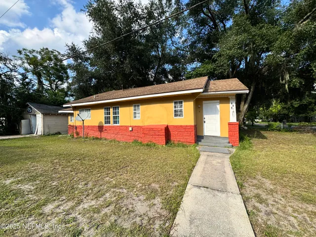 a front view of house with yard and trees