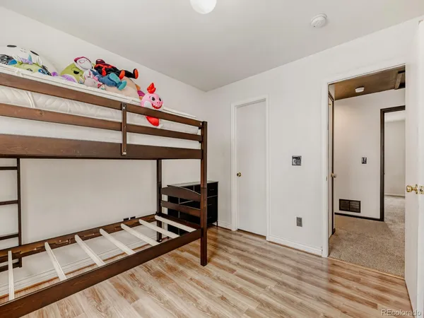 a bedroom with furniture and a wooden floor