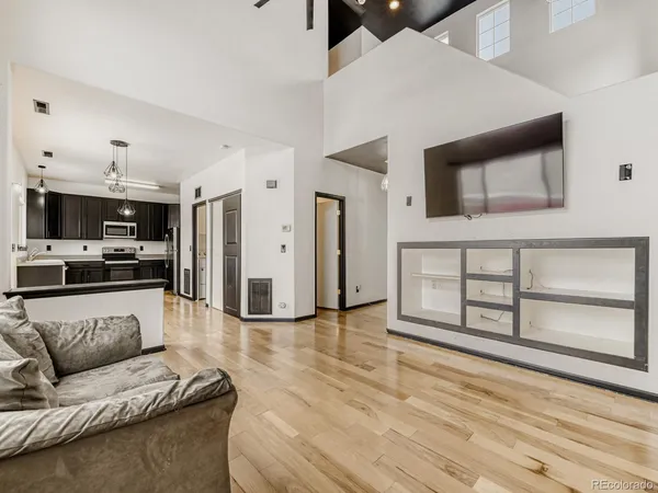 a living room with furniture and kitchen view