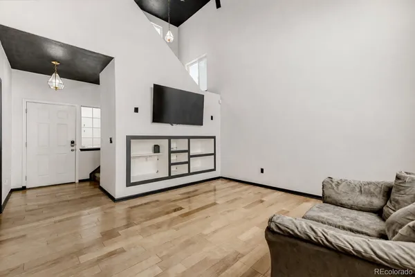 a living room with furniture and a flat screen tv