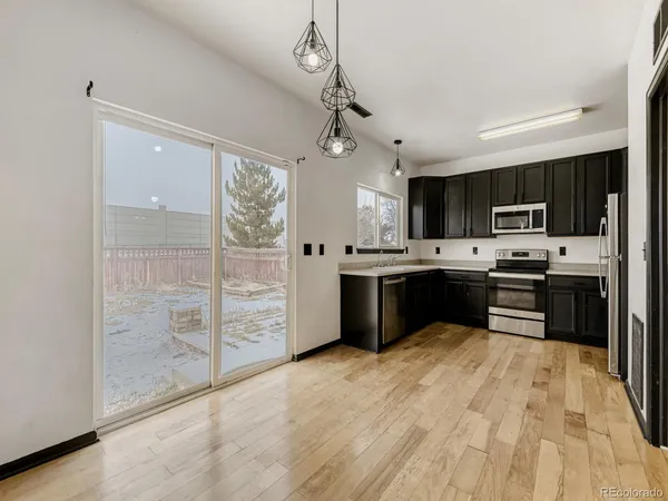 a kitchen with stainless steel appliances a refrigerator sink and microwave