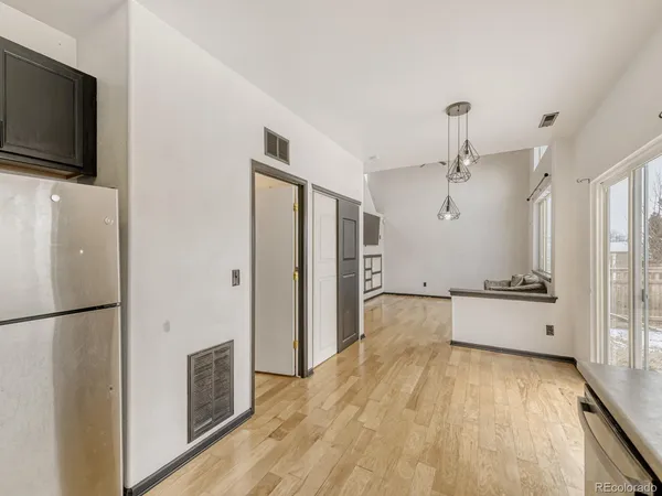 a kitchen with stainless steel appliances a refrigerator and a stove top oven