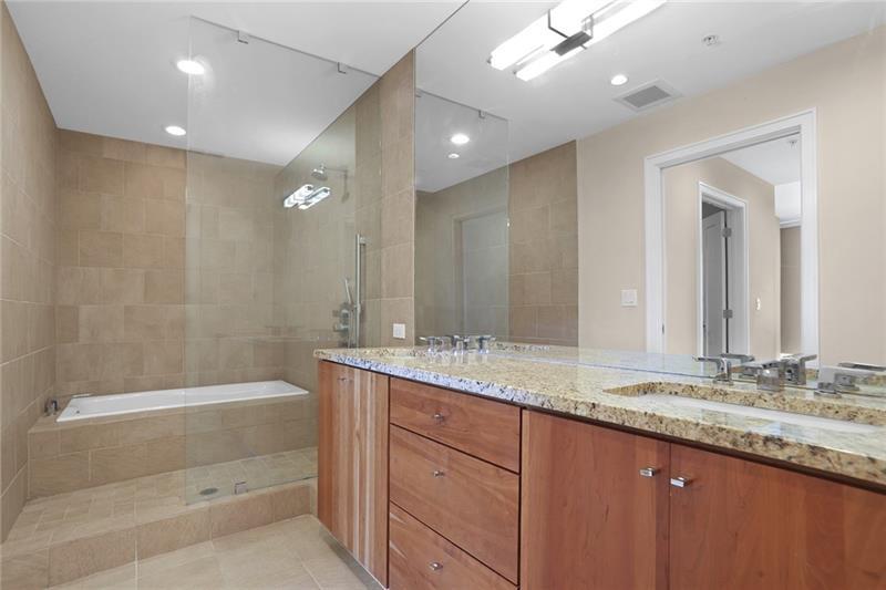 3325 Piedmont Road Northeast, Unit 2404 Atlanta, GA 30305 - Photo 15 of 36 a bathroom with a granite countertop sink mirror and bathtub