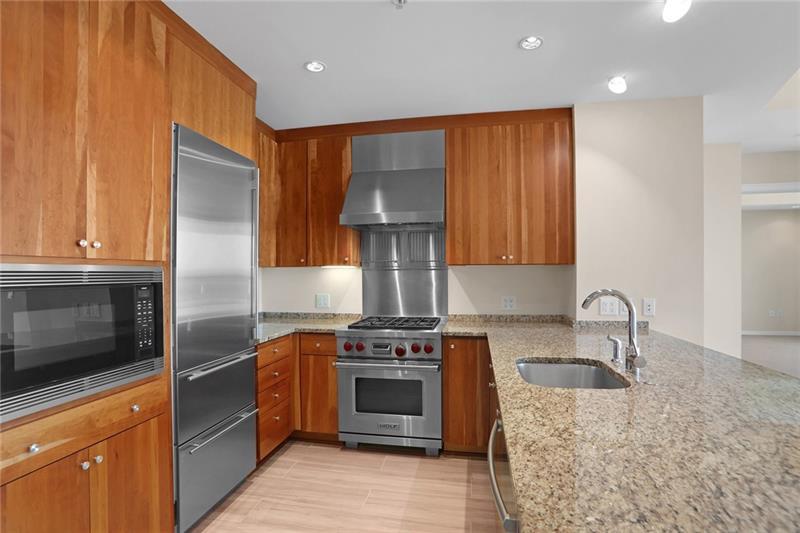 3325 Piedmont Road Northeast, Unit 2404 Atlanta, GA 30305 - Photo 2 of 36 a kitchen with stainless steel appliances granite countertop a stove a sink and a refrigerator