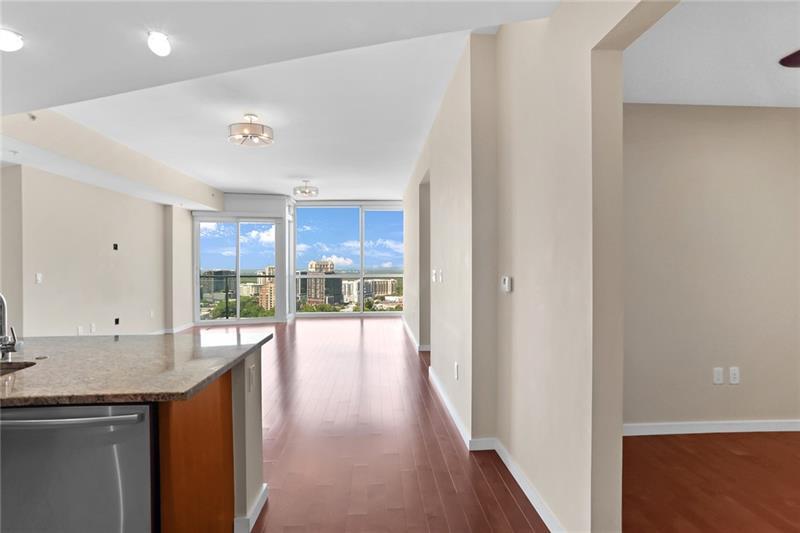 3325 Piedmont Road Northeast, Unit 2404 Atlanta, GA 30305 - Photo 3 of 36 a view of a hallway with wooden floor and a kitchen space
