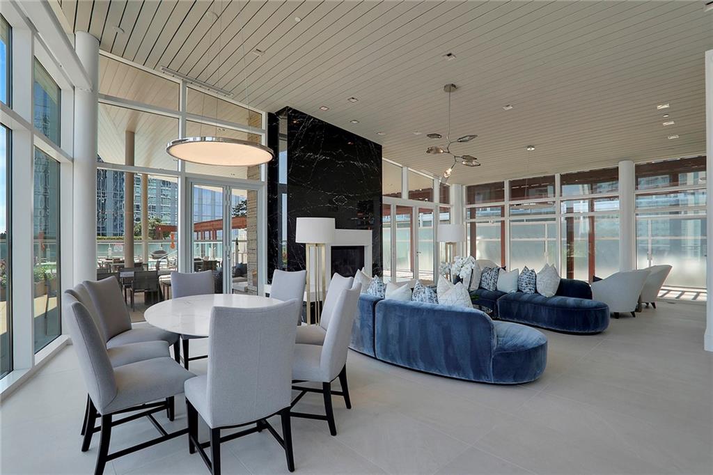 3325 Piedmont Road Northeast, Unit 2404 Atlanta, GA 30305 - Photo 31 of 36 a living room with fireplace furniture and a large window