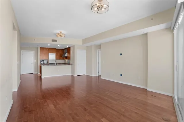 a view of a kitchen with a sink and a refrigerator