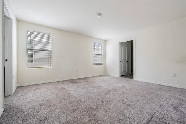 a view of a livingroom with furniture and a ceiling fan
