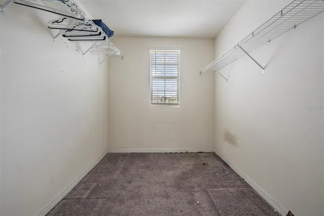 a view of a room with racks on the wall and a window
