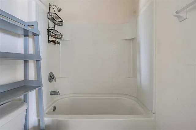 a aerial view of a house with a yard and large tree