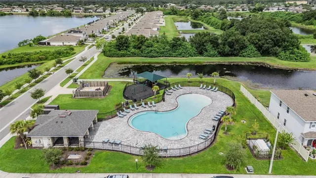 an aerial view of a house with outdoor space and lake view