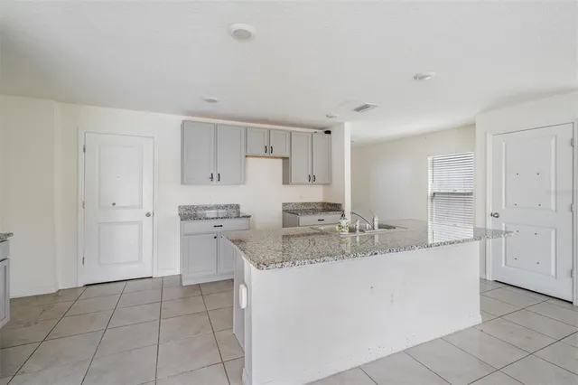 a kitchen with stainless steel appliances granite countertop a sink and cabinets