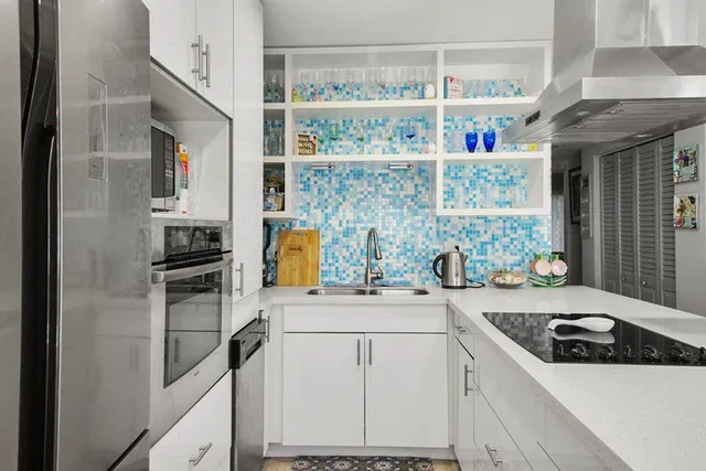 a kitchen with a sink a stove and refrigerator