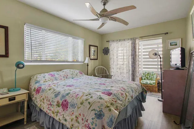 a bedroom with a bed dresser and a window