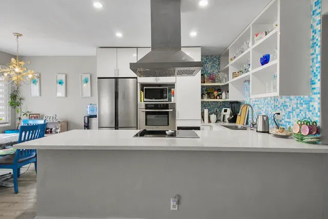 a view of kitchen with furniture and refrigerator