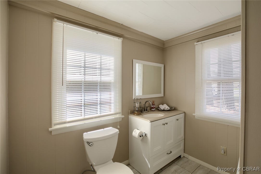 10371 Buckley Hall Road Mathews, VA 23109 - Photo 19 of 28 Half bathroom featuring a wealth of natural light, toilet, and vanity