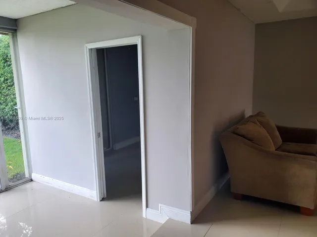 a living room with a couch and a window