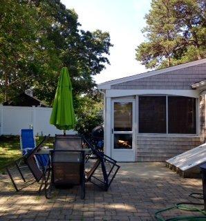 12 Captain Chase Road Dennis Port, MA 02639 - Photo 14 of 14 a backyard of a house with barbeque oven table and chairs