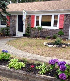 12 Captain Chase Road Dennis Port, MA 02639 - Photo 3 of 14 a front view of house with flowers