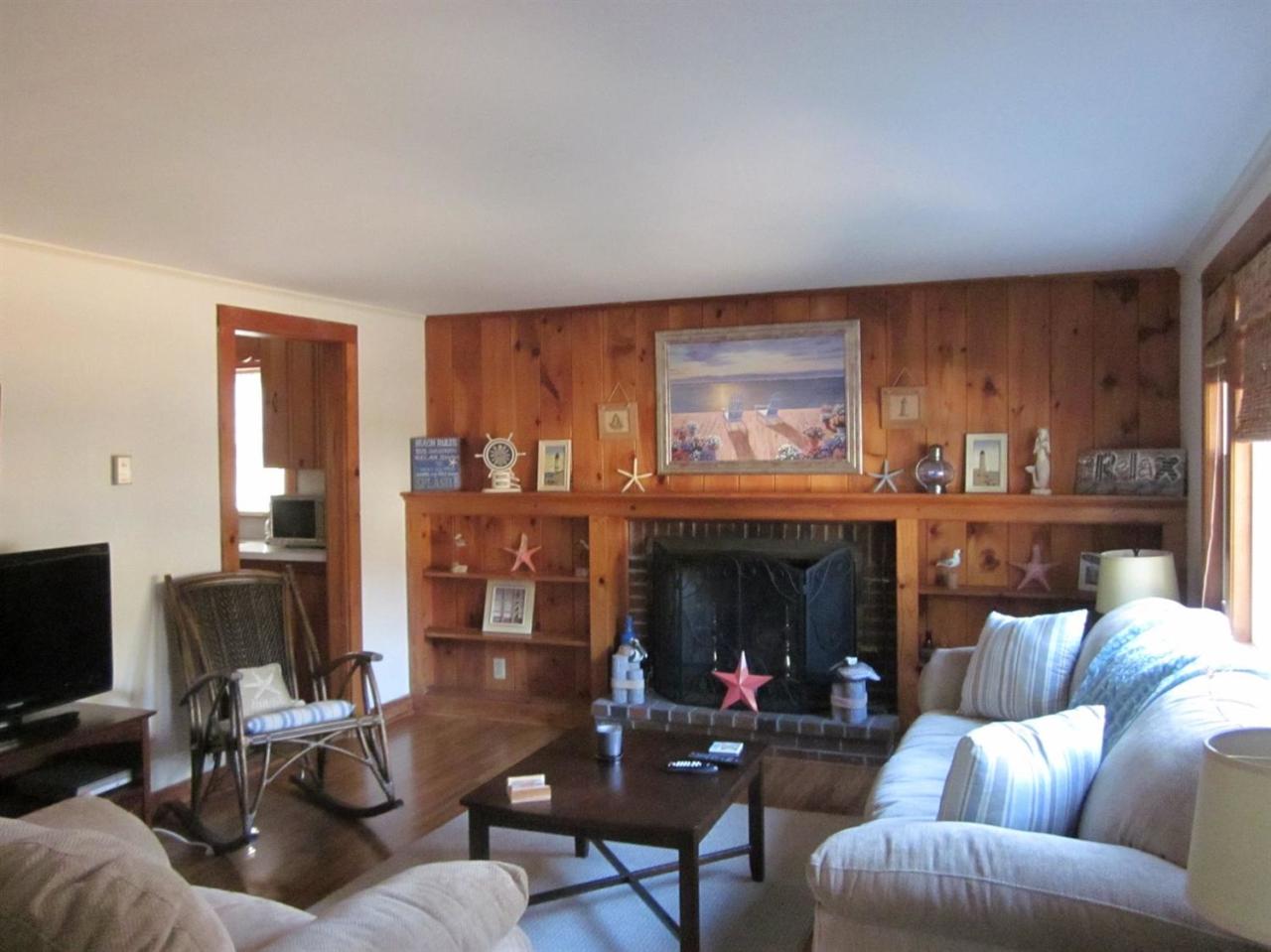 12 Captain Chase Road Dennis Port, MA 02639 - Photo 5 of 14 a living room with furniture and a fireplace