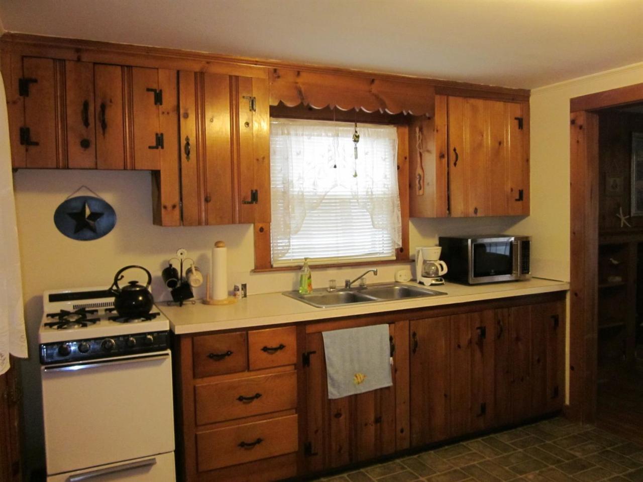 12 Captain Chase Road Dennis Port, MA 02639 - Photo 7 of 14 a kitchen with a sink a stove and cabinets