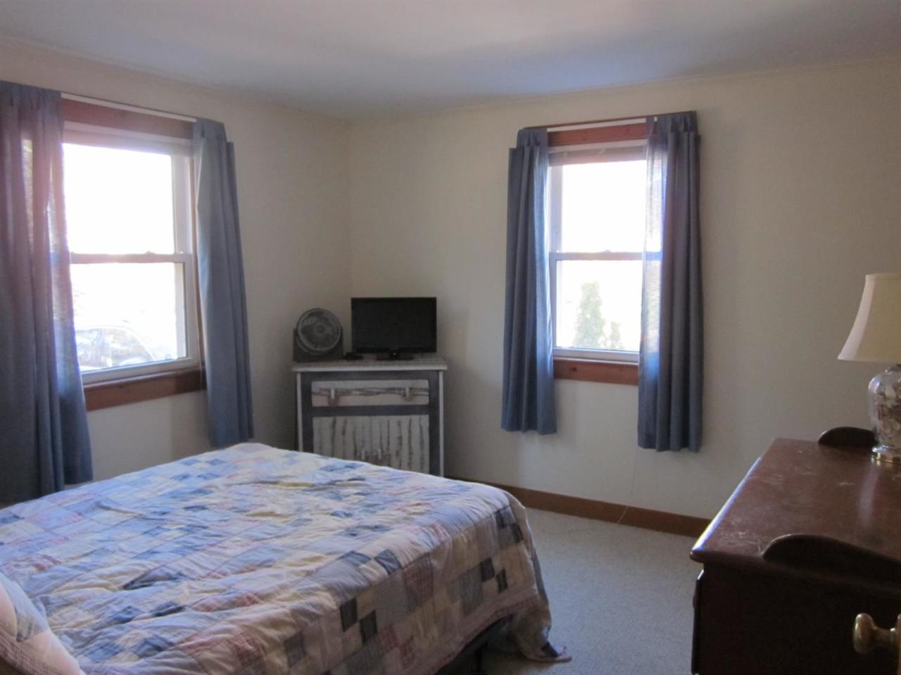 12 Captain Chase Road Dennis Port, MA 02639 - Photo 9 of 14 a bedroom with a bed and a flat screen tv