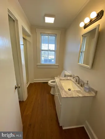 a bathroom with a sink a window and a mirror