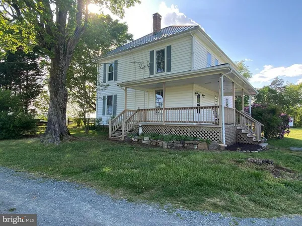 a view of backyard with a garden and deck