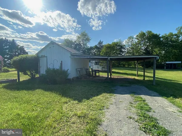 a view of a chair and table in the garden