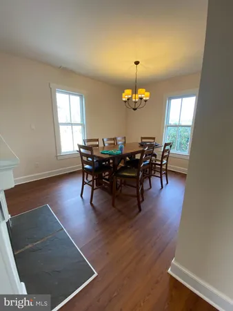 a view of a dining room with furniture and chandelier